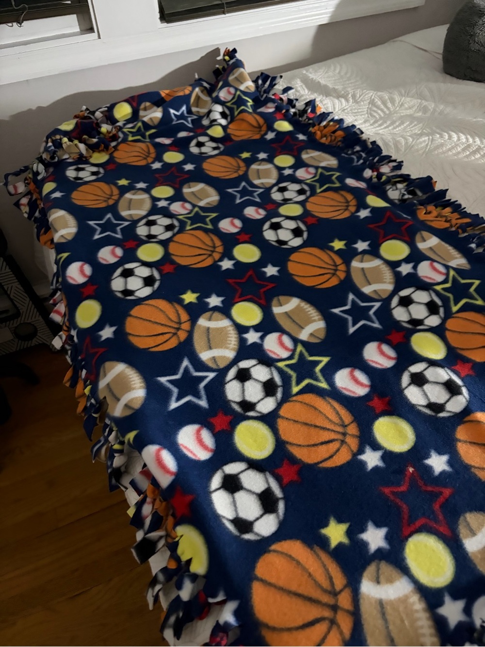Sports Print Fleece Tie-Blanket in Navy with Orange & Yellow Accents.